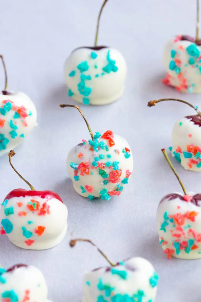 4th of July Desserts: White Chocolate Covered Fresh Cherries sprinkled with red and blue pop rocks