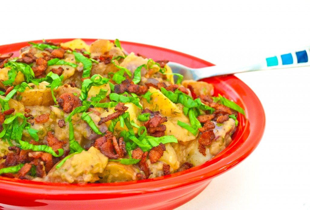 Red White and Blue Potato Salad topped with chopped fresh parsley in red Fiestaware Platter