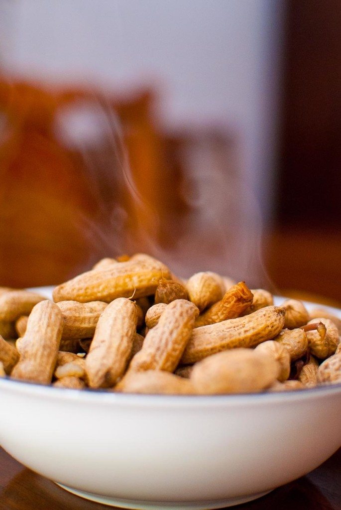 Steaming boiled peanuts in a white bowl