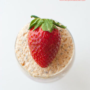 Close up of strawberry on peanut butter and jelly overnight oats