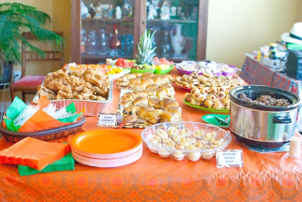 tablescape of safari theme party with orange table cloth