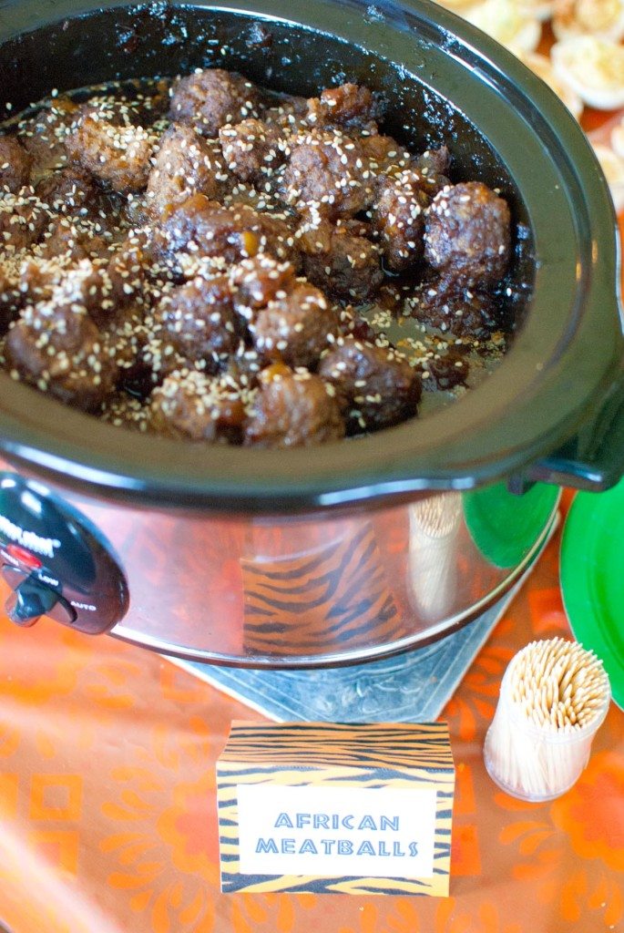 African meatballs in a crockpot sprinkled with sesame seeds