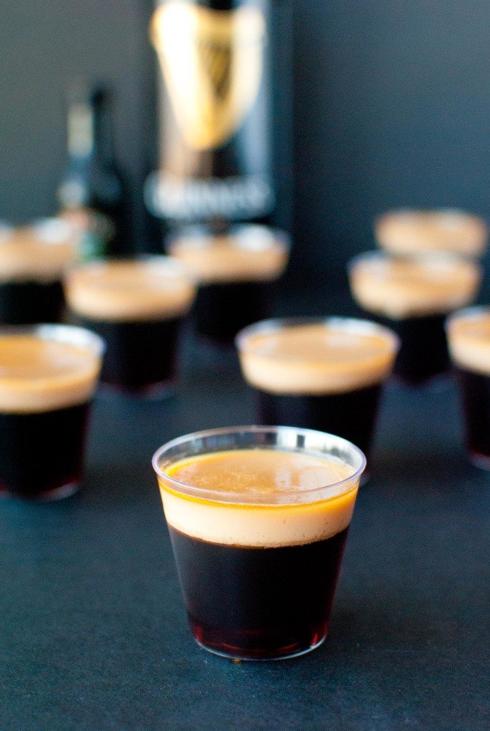 several baby guinness jello shots with a can of guinness beer in the background