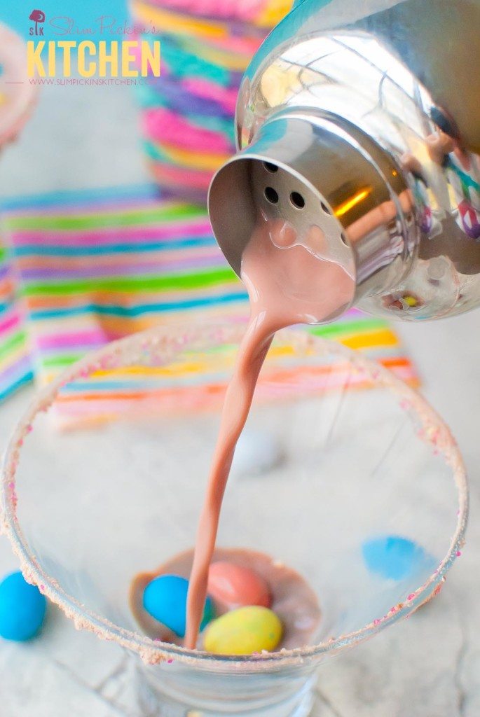 Spring drink cocktail robin egg martini being poured into a martini glass