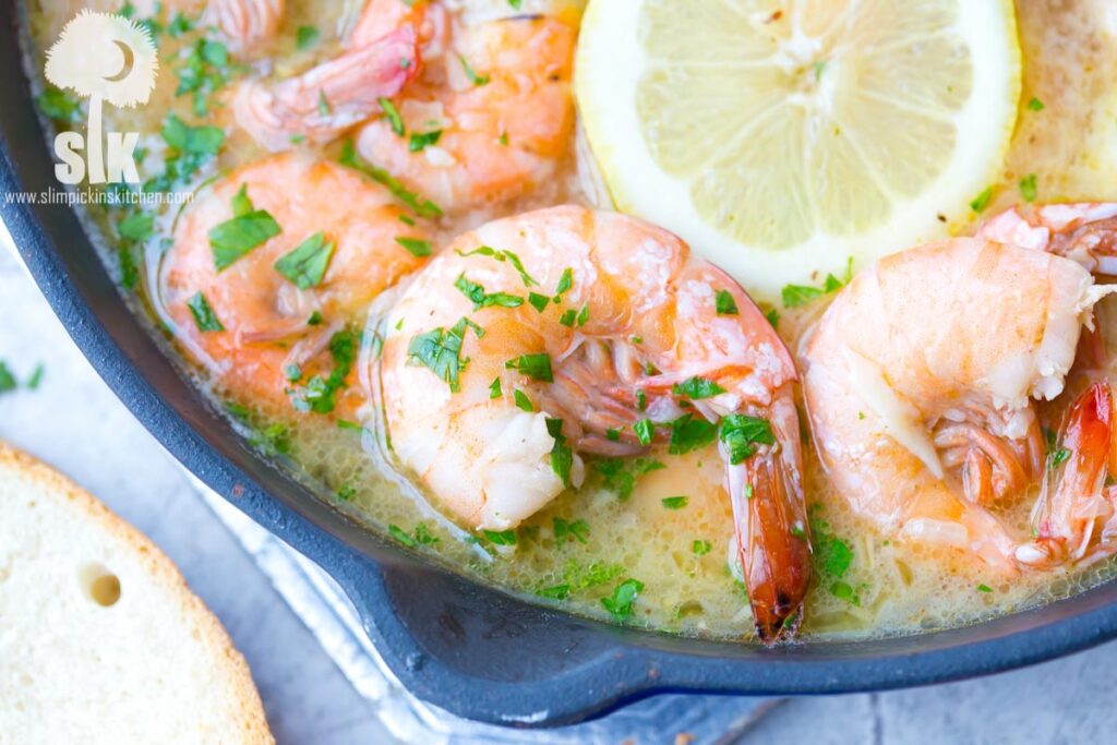 Lemon Shandy Peel and Eat Shrimp Recipe: A quick and easy peel and eat shrimp recipe that's made with lemon shandy beer, fresh garlic and herbs, butter and steamed shrimp! 