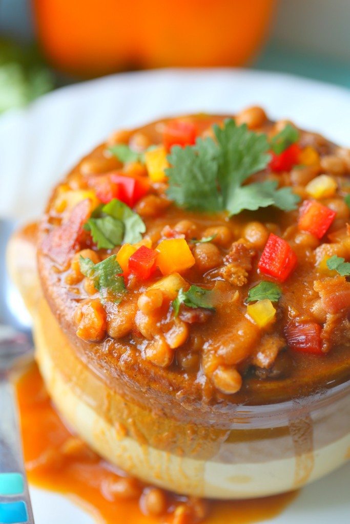 Baked Beans in a brown baking pot with red, yellow and green peppers