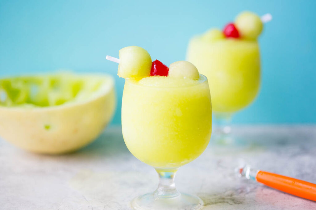 Spiked Melon Ball Slushies: A frozen twist on the classic melon ball drink made with freshly frozen Honeydew, melon liquor, melon vodka, and sweet pineapple juice. 