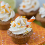 mini mango margarita cupcakes with a tiny orange and white striped straw