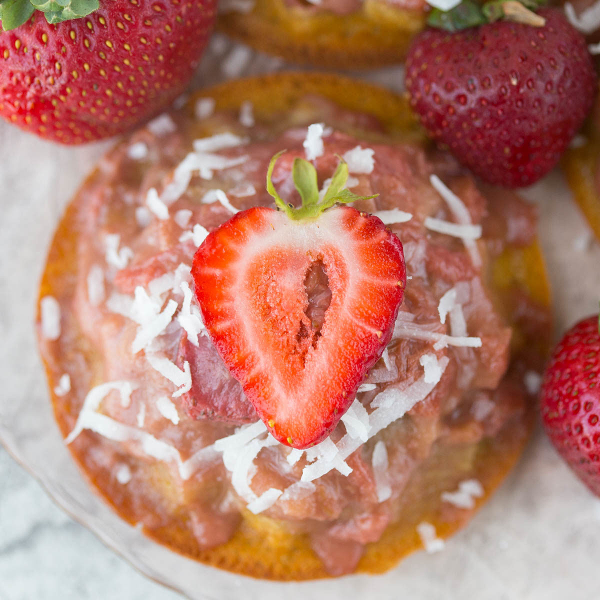 Mini Gluten Free Strawberry Rhubarb Upside Down Cake Recipe: ursting with sweet strawberries, sour rhubarb, and a spritz of summery lemon, these gluten-free & refined sugar-free w/ vegan option Strawberry Rhubarb Upside Down Cakes taste like a breezy summer day in the Southern sun!