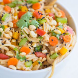 Spicy Thai noodles are a quick and easy dinner recipe that can be ready in under 20 minutes! The smooth, velvety peanut sauce mixed with the crunch of the fresh veggies will make you want to add this to your weekly meal plan.