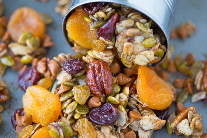 maple pumpkin trail mix wih pcans, apricots, and dried cranberries spilling out of a tin can