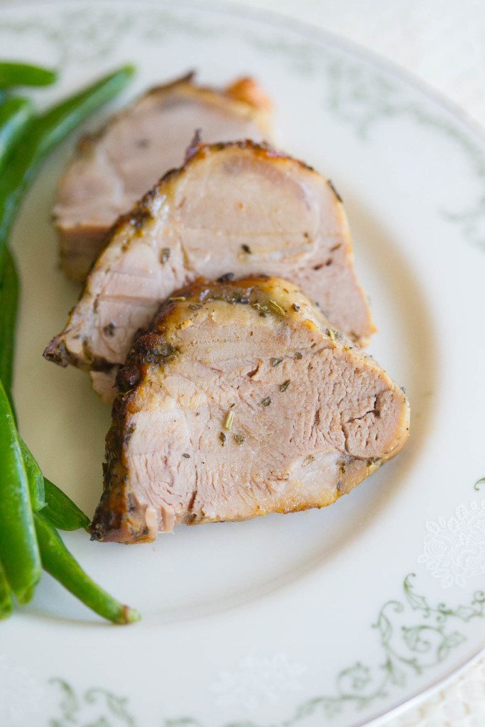 Three Slices of Easy Roasted Pork Tenderloin on a Plate with Green Beans