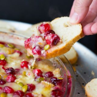 Cranberry orange baked brie dip is a super easy, fun, and festive holiday appetizer recipe that's perfect for your Thanksgiving or Christmas feast!