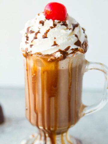 hot chocolate with whipped cream and a cherry on top