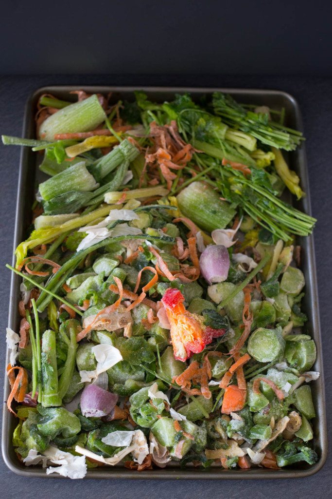 Vegetable scraps on a sheet pan for vegetable stock