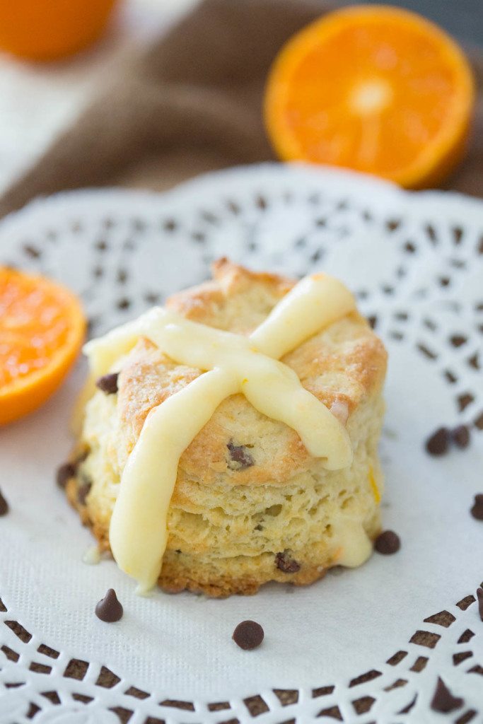 Hot Cross Orange chocolate chip biscuit on a plate with orange cream cheese cross