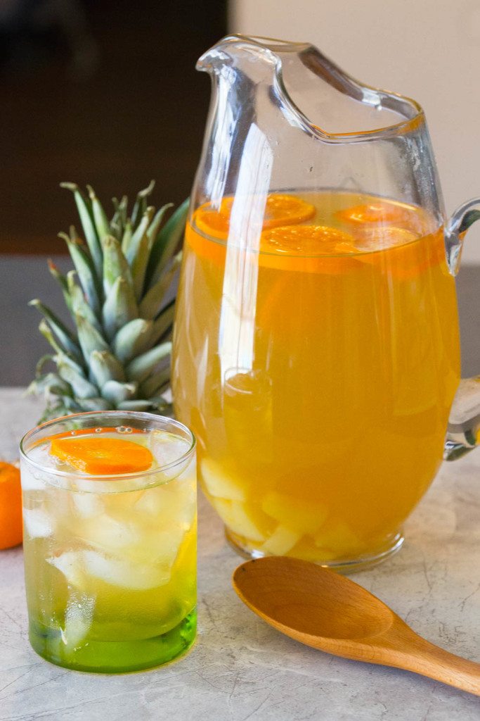 Home brewed Pineapple Orange Green Tea is crisp and cool with a hint of citrus and pineapple to get you ready for spring! Serve as is for a family friendly St. Patrick's Day, Mother's Day, or Easter drink or sassify it w/ a shot of rum or Irish whiskey. 