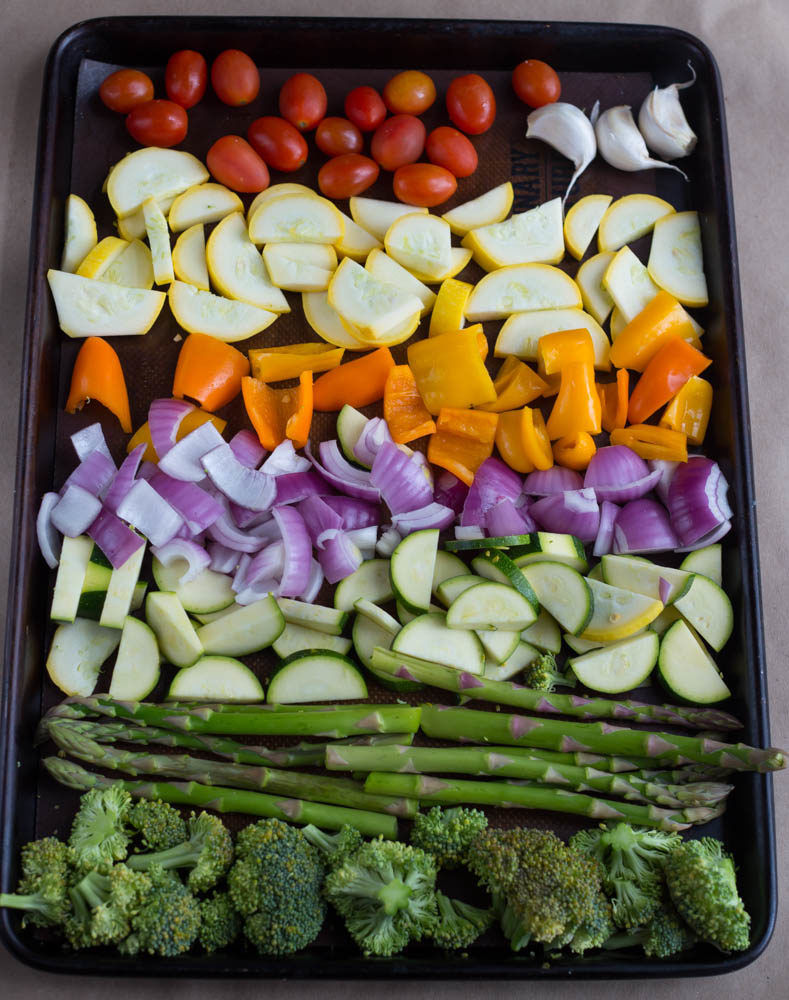 cut fresh vegetables on a roasting pan before roasting for a side dish