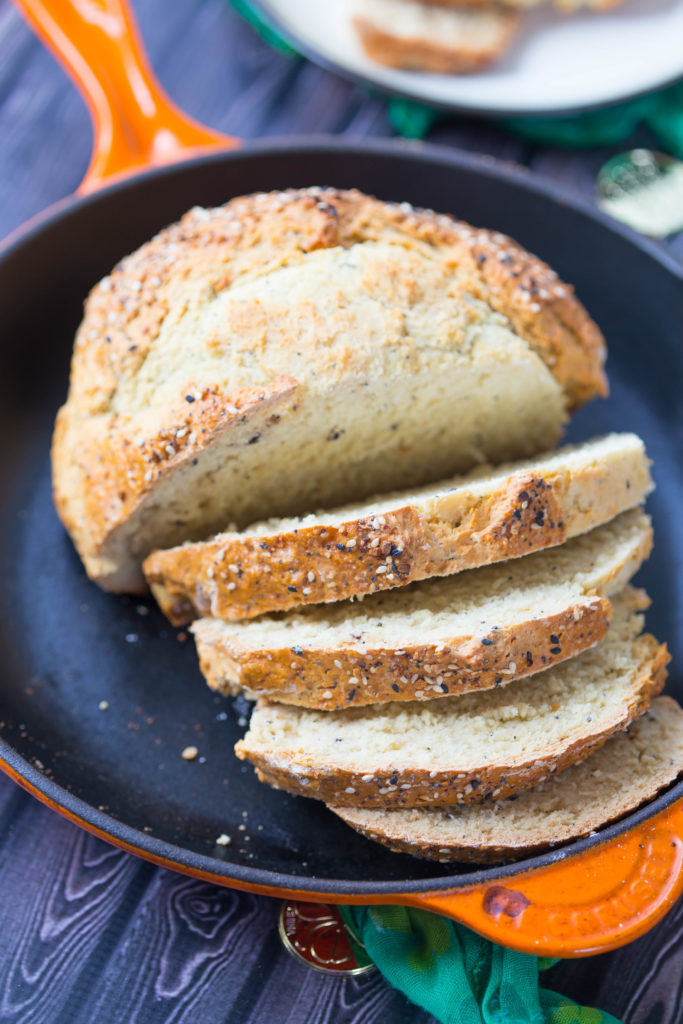 Slices of Everything Irish Soda Bread in Orange Le Creuset Cast Iron Skillet