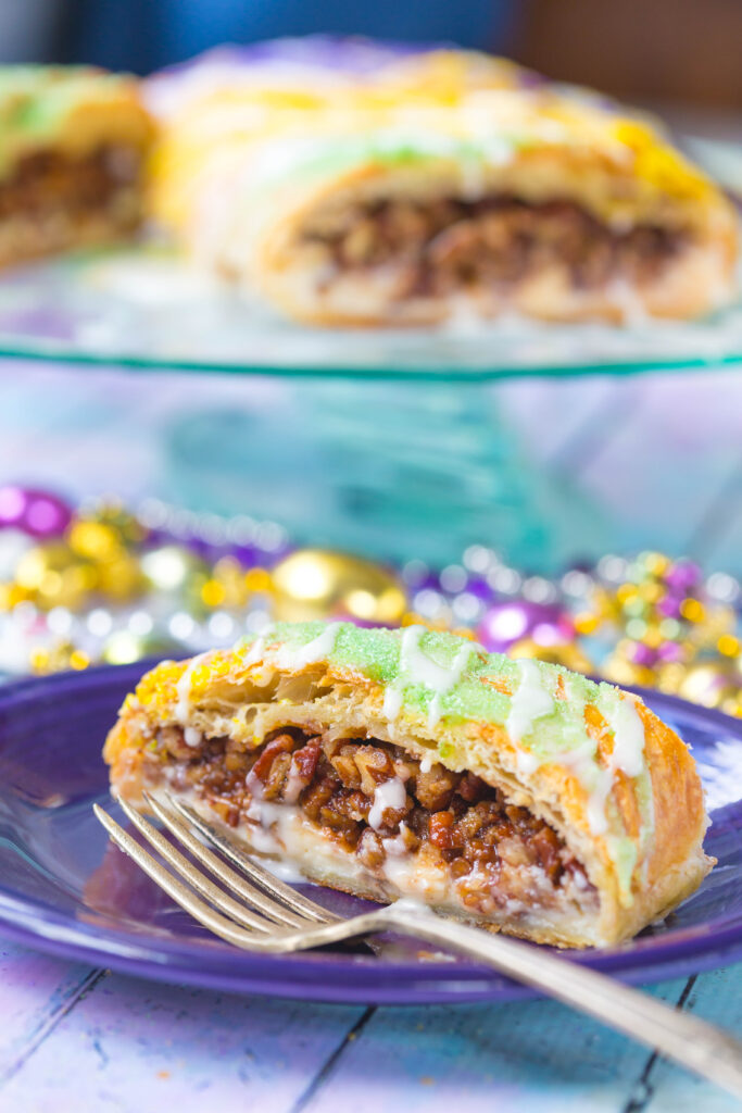 Sliced Pecan Praline Puff Pastry on a purple plate with silver fork