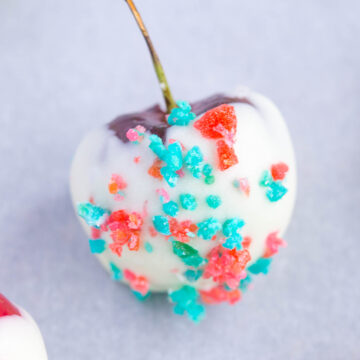 Close up of white chocolate covered cherry 4th of July Cherry Bombs with red and blue pop rocks