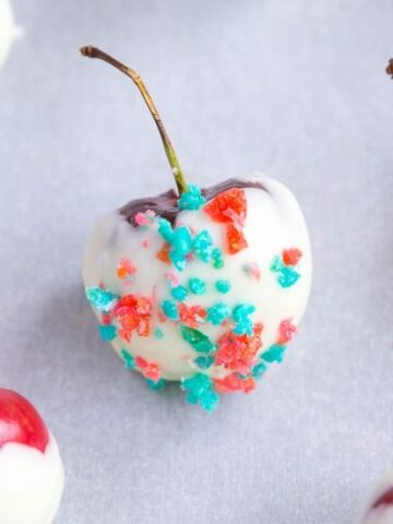Close of of white chocolate covered cherry 4th of july cherry bombs with red and blue pop rocks