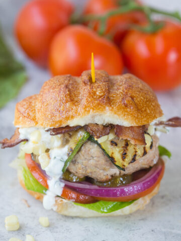 Close up of turkey burger w/ dripping goat cheese spread