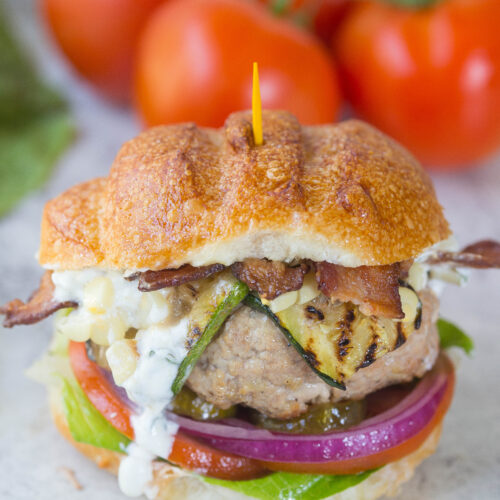 Close up of turkey burger w/ dripping goat cheese spread