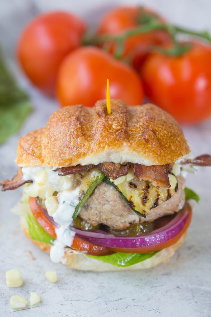 Close up of turkey burger w/ dripping goat cheese spread