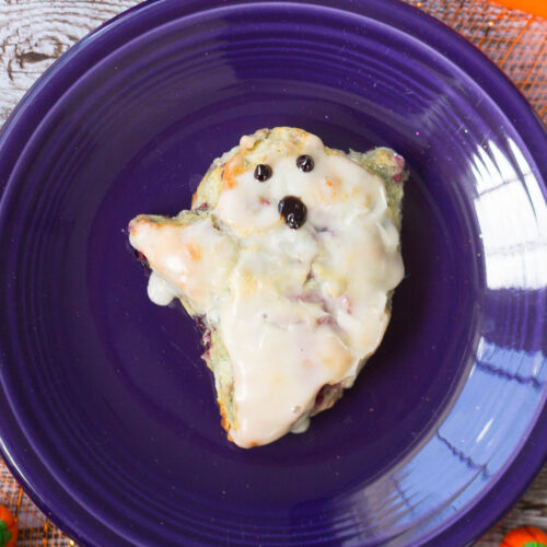 Close up shot of blueberry biscuit shaped and decorated like a ghost