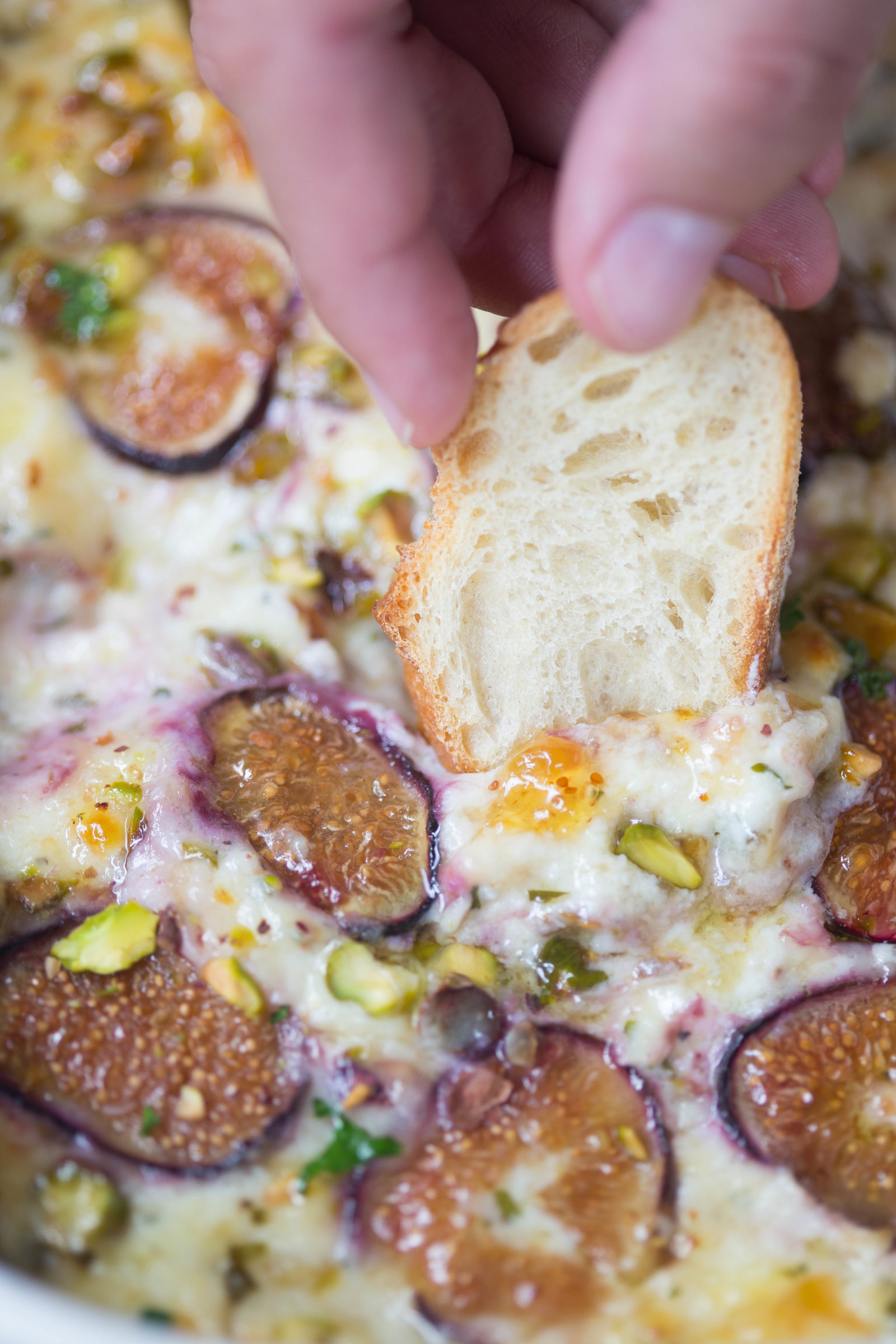 Close up of fig preserves, baked figs, and ricotta dip