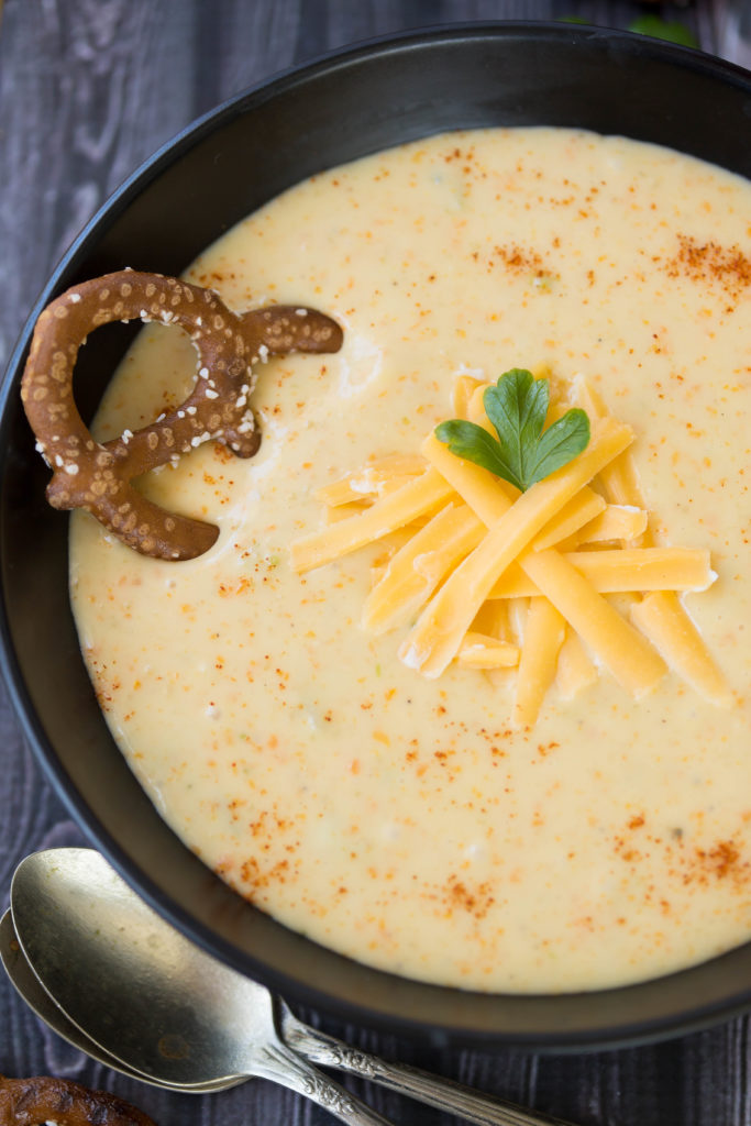 Close up of Octoberfest Beer Cheese Soup w/ Smoked Paprika and other toppings