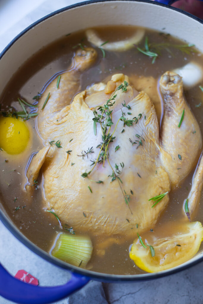 Raw Chicken surrounded by lemons in sweet tea brine