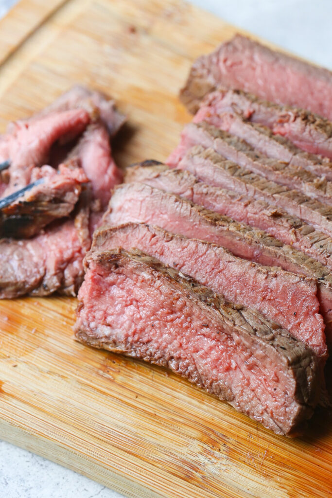 Slices of London Broil on cutting board