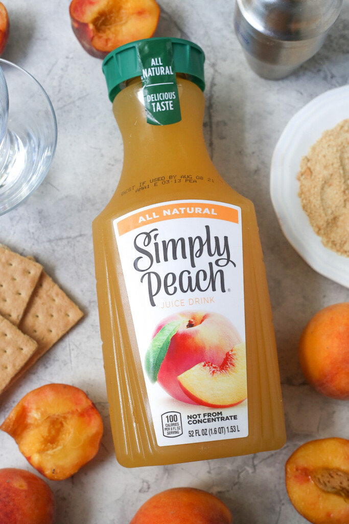Simply peach peach juice surrounded by fresh peaches and graham crackers