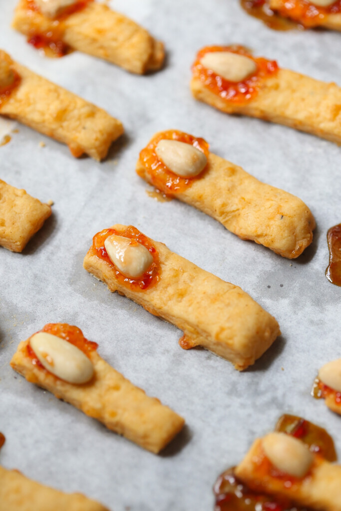 witch fingers cheese straws on a baking sheet with parchment paper