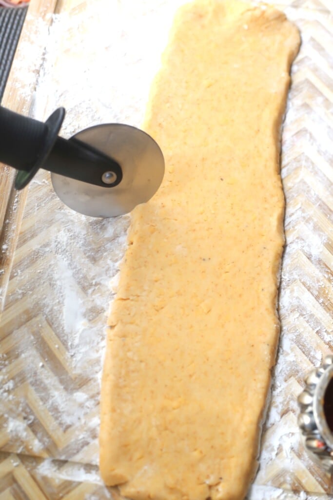 witch fingers cheese straws being cut with a pizza cutter
