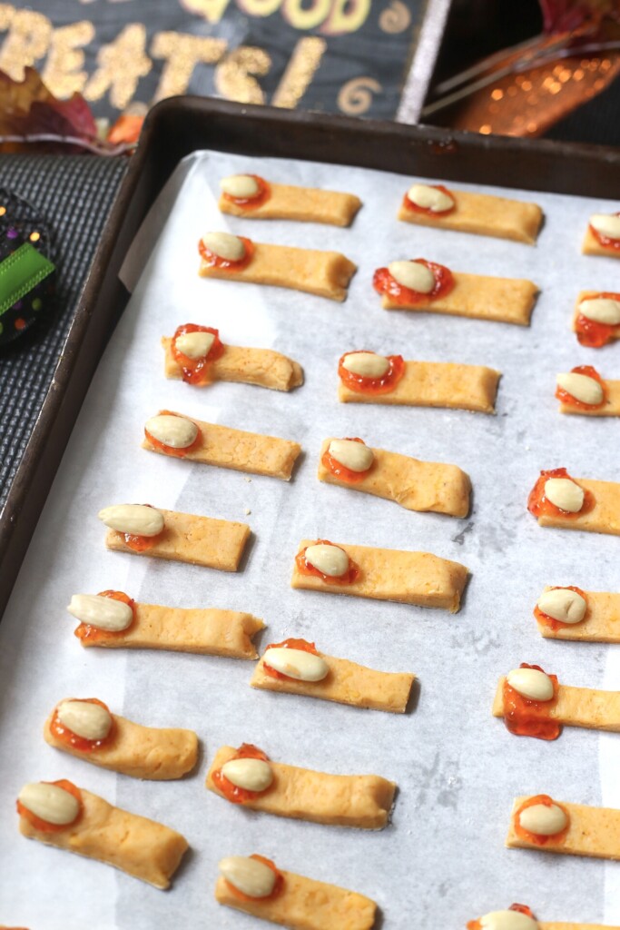 a tray of uncooked Halloween witch fingers cheese straws