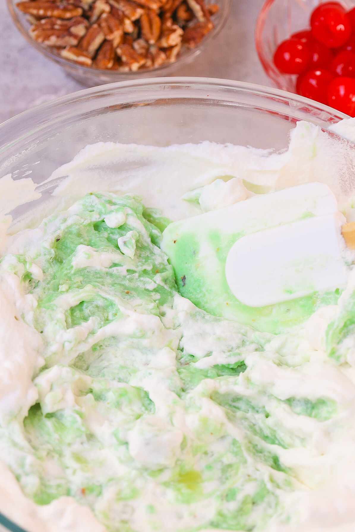 Ambrosia Watergate Salad with coconut pistachio pudding mixed with homemade whipped cream