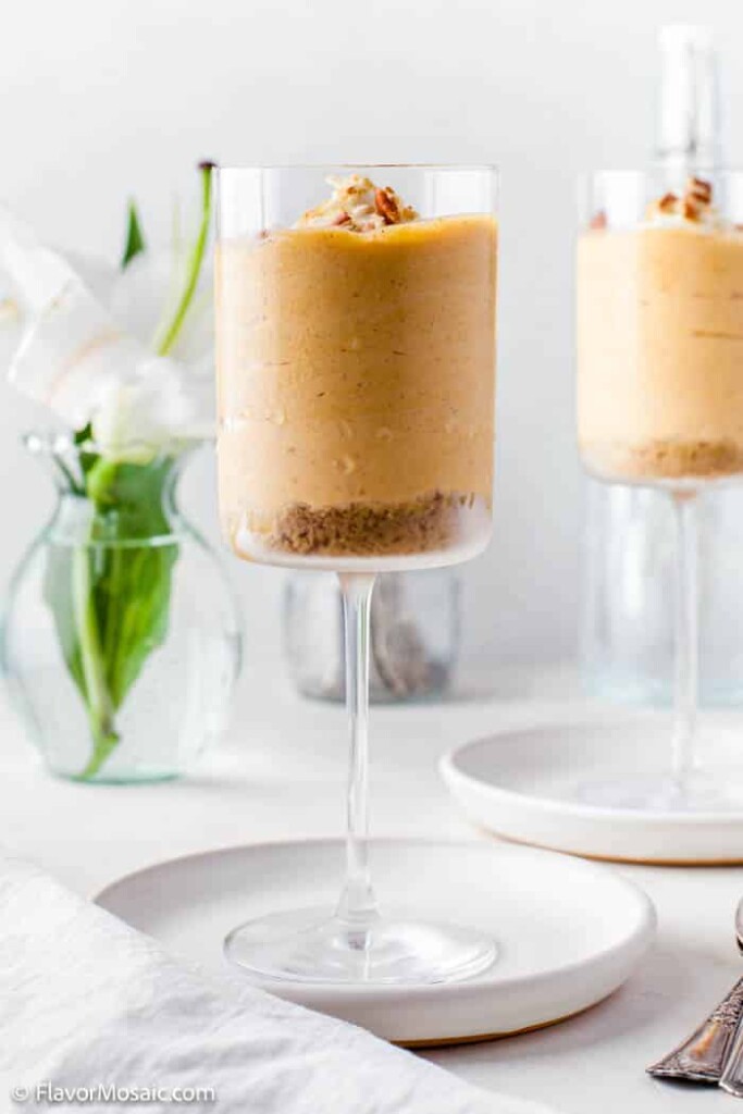 easy no bake pumpkin cheese cake mousse in a tall glass on a white table