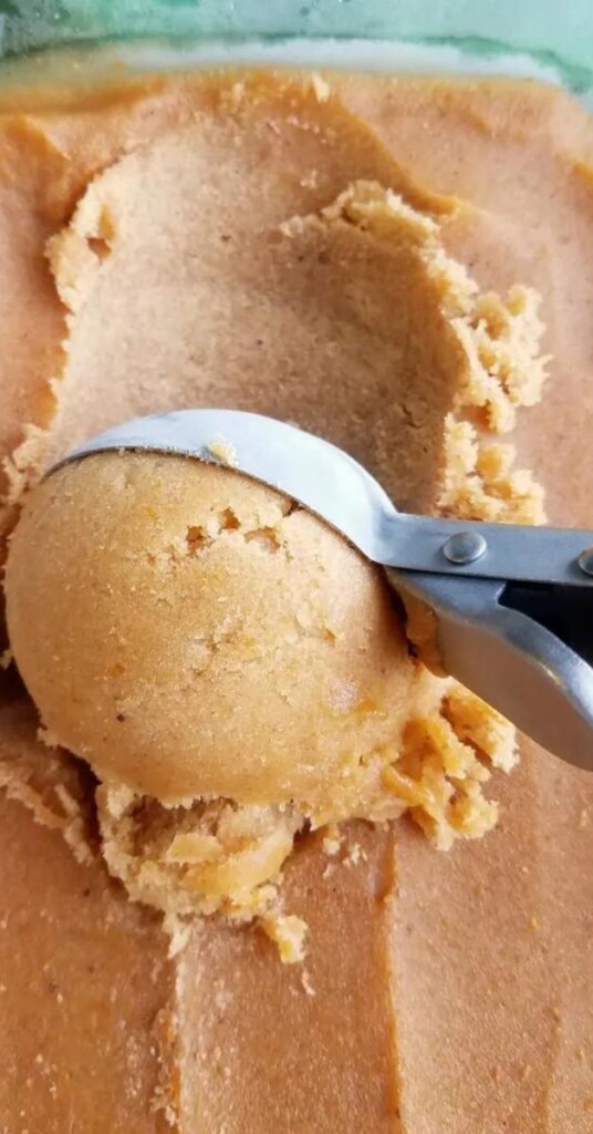 Pumpkin nice cream being scooped out of dish
