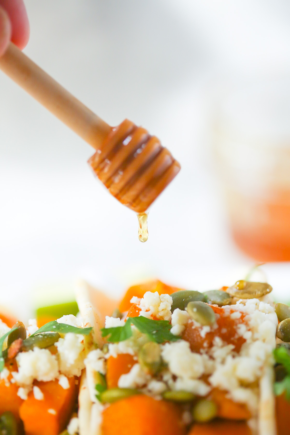 butternut squash tacos being drizzled with honey