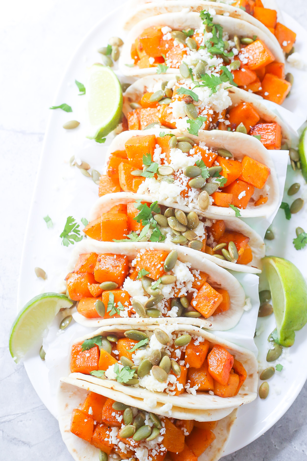 Butternut squash tacos on a white plate