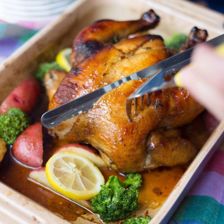 sweet tea chicken being slice with a carving knife and fork