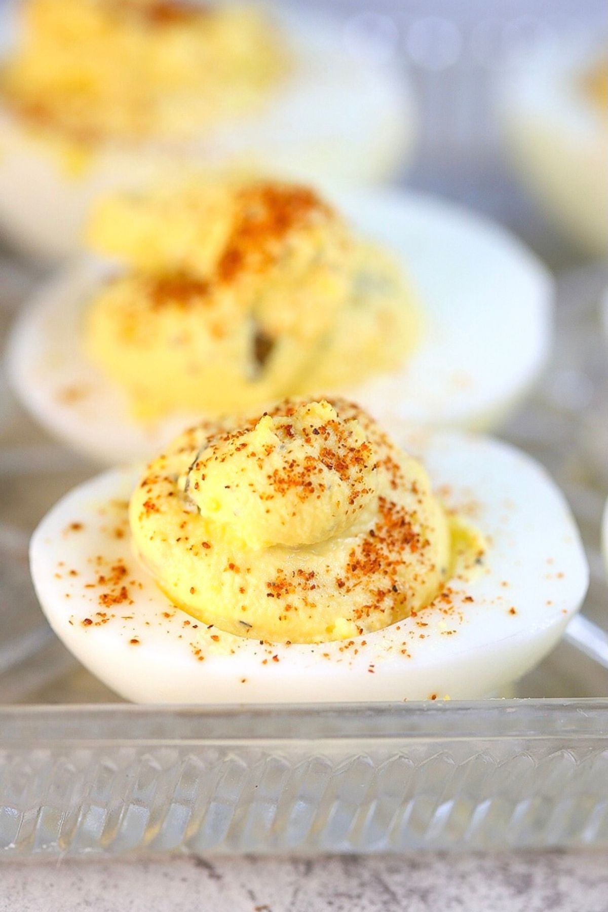Close up of southern deviled eggs on a clear serving tray