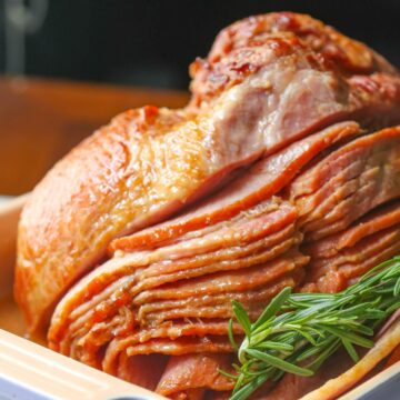 Close up of whole spiral ham (honey glazed ham) garnished with rosemary