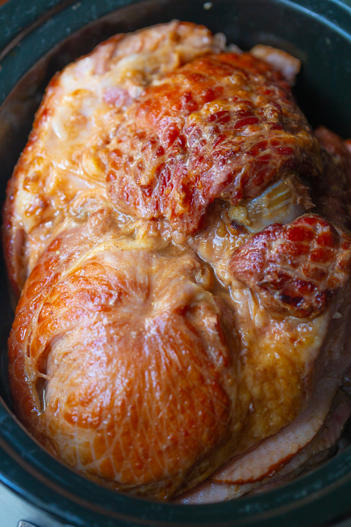 A spiral ham in a slow cooker insert